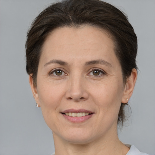 Joyful white adult female with medium  brown hair and brown eyes