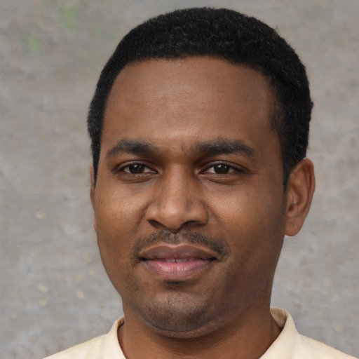 Joyful latino adult male with short  black hair and brown eyes