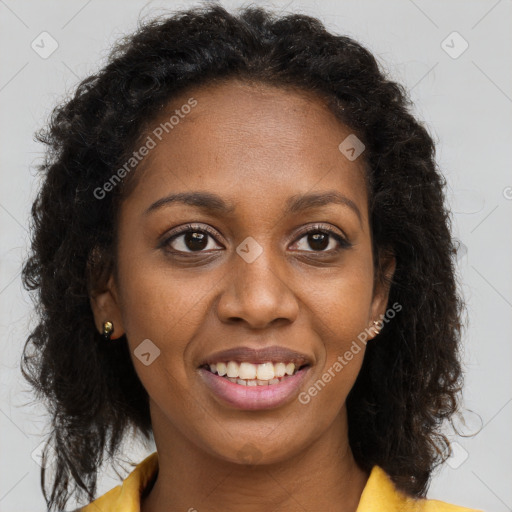 Joyful black young-adult female with long  brown hair and brown eyes