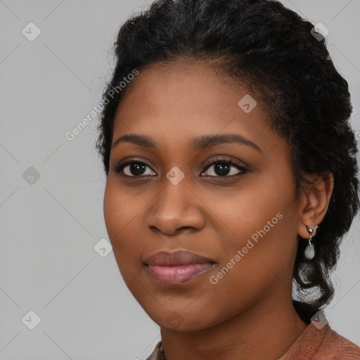 Joyful black young-adult female with long  black hair and brown eyes