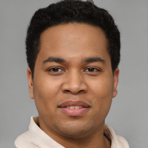 Joyful latino young-adult male with short  brown hair and brown eyes