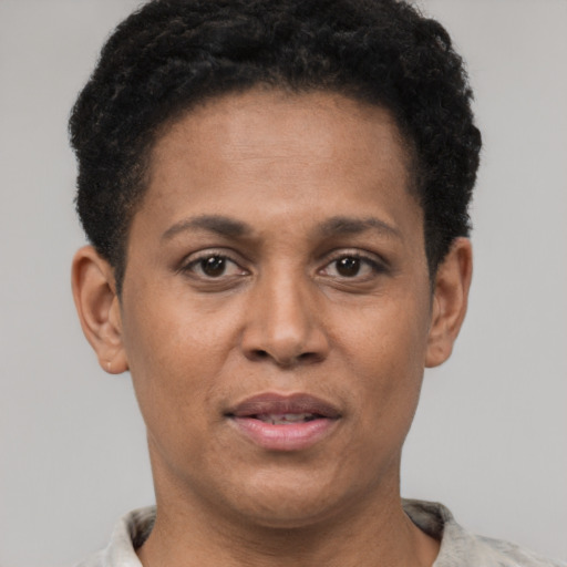 Joyful black adult female with short  brown hair and brown eyes