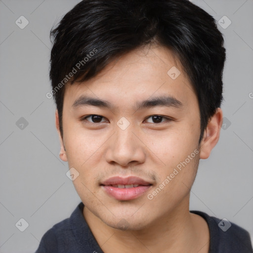 Joyful asian young-adult male with short  black hair and brown eyes