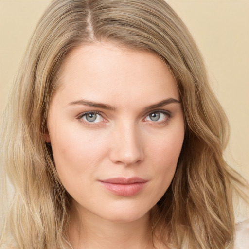 Joyful white young-adult female with long  brown hair and green eyes