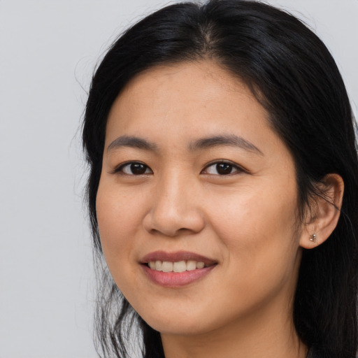 Joyful asian young-adult female with long  black hair and brown eyes