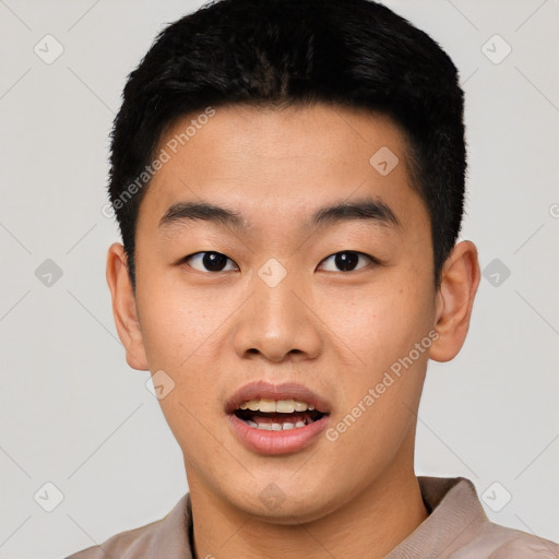 Joyful asian young-adult male with short  black hair and brown eyes