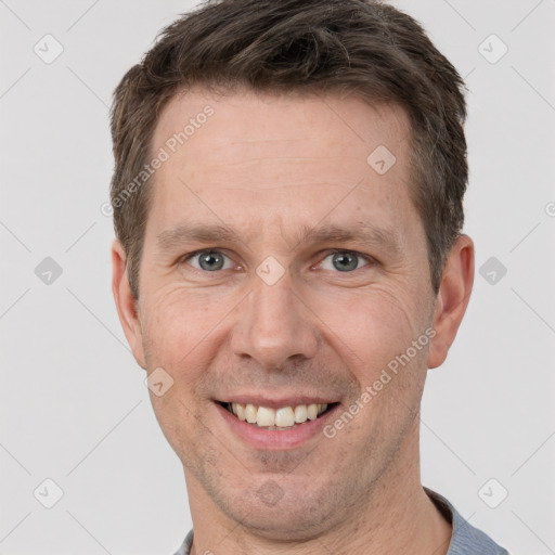 Joyful white adult male with short  brown hair and grey eyes