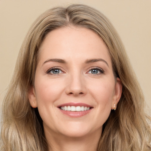 Joyful white young-adult female with long  brown hair and green eyes