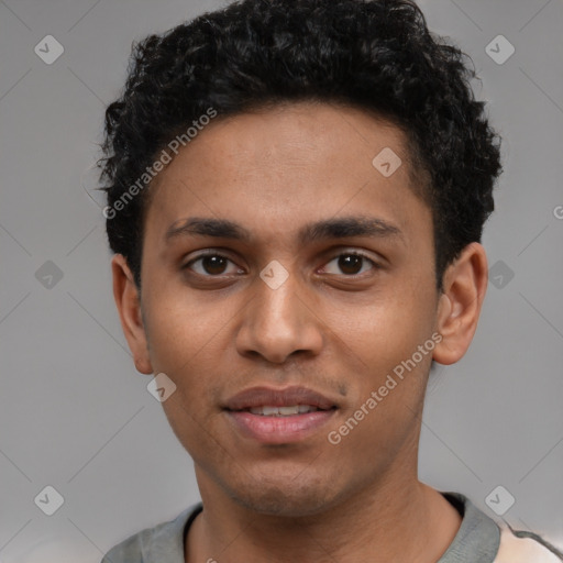 Joyful latino young-adult male with short  brown hair and brown eyes