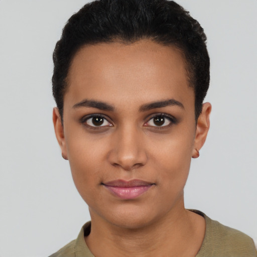 Joyful latino young-adult female with short  black hair and brown eyes