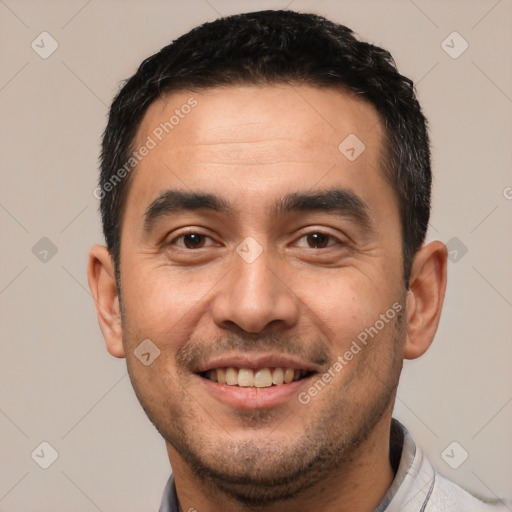 Joyful white young-adult male with short  black hair and brown eyes