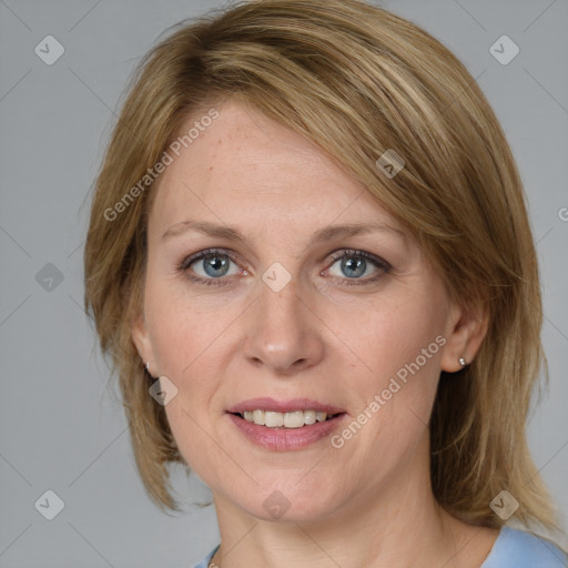 Joyful white adult female with medium  brown hair and blue eyes