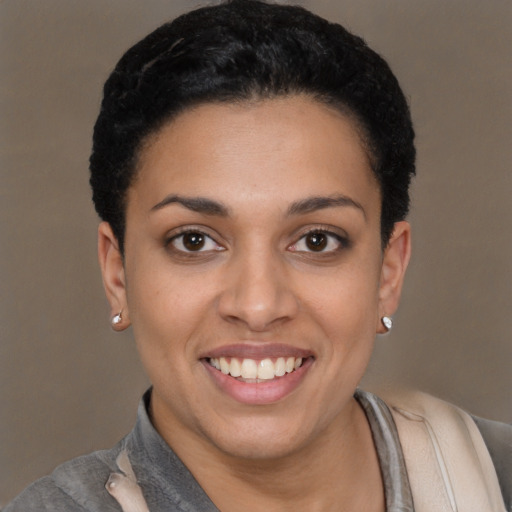 Joyful latino young-adult female with short  black hair and brown eyes