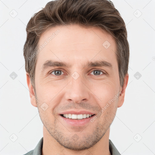 Joyful white young-adult male with short  brown hair and grey eyes