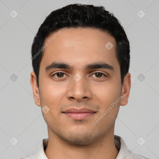 Joyful latino young-adult male with short  black hair and brown eyes