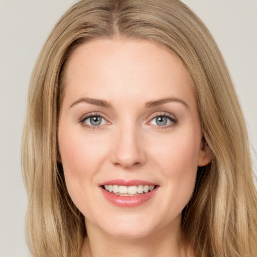 Joyful white young-adult female with long  brown hair and green eyes