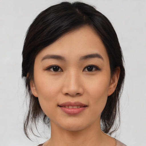 Joyful asian young-adult female with medium  black hair and brown eyes