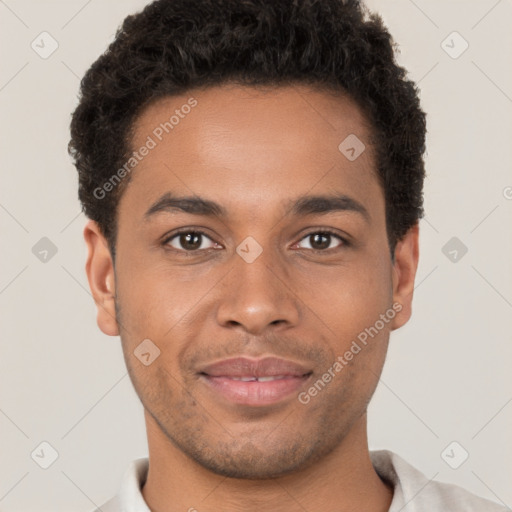 Joyful black young-adult male with short  brown hair and brown eyes