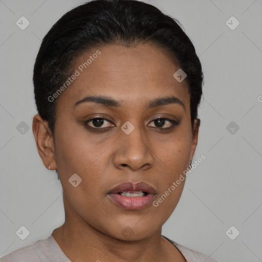 Joyful black young-adult female with short  black hair and brown eyes