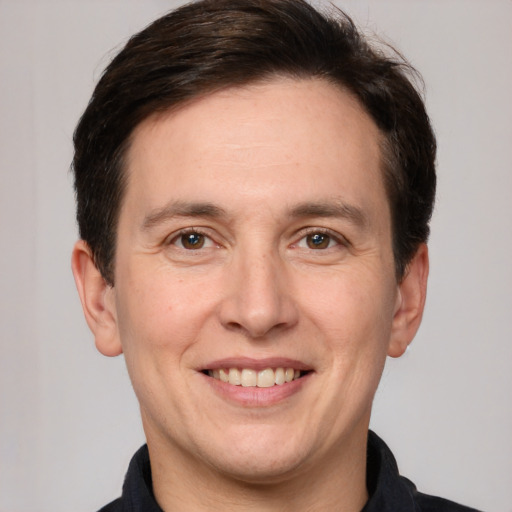 Joyful white adult male with short  brown hair and brown eyes