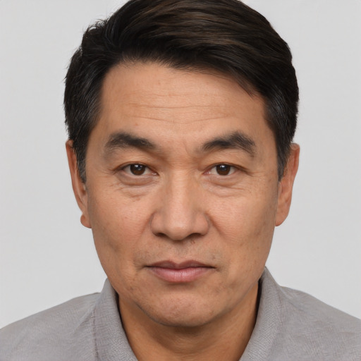 Joyful white adult male with short  black hair and brown eyes