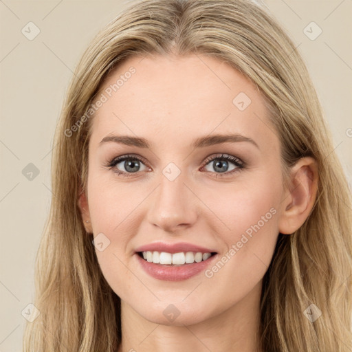 Joyful white young-adult female with long  brown hair and green eyes