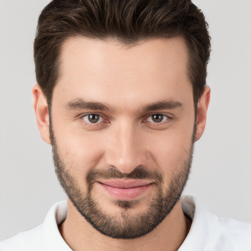 Joyful white young-adult male with short  brown hair and brown eyes