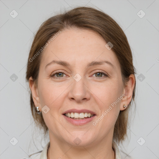 Joyful white adult female with medium  brown hair and grey eyes