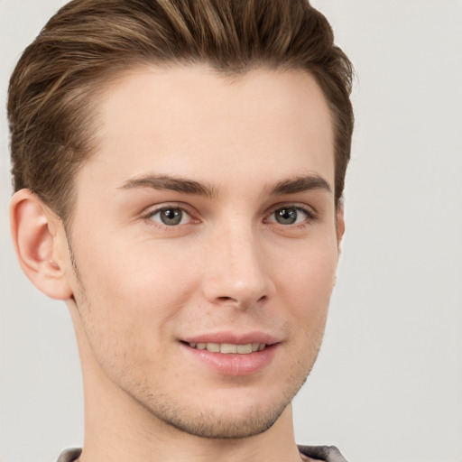 Joyful white young-adult male with short  brown hair and grey eyes