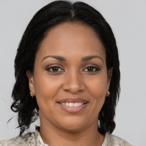 Joyful black young-adult female with medium  brown hair and brown eyes