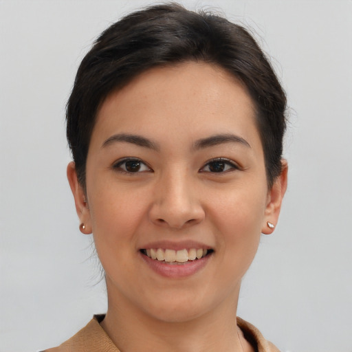 Joyful latino young-adult female with short  brown hair and brown eyes