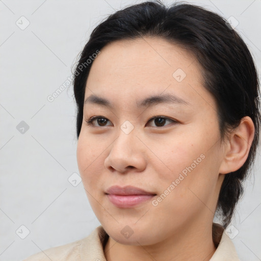 Joyful asian young-adult female with medium  brown hair and brown eyes