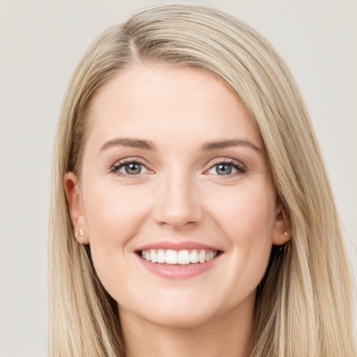 Joyful white young-adult female with long  brown hair and blue eyes