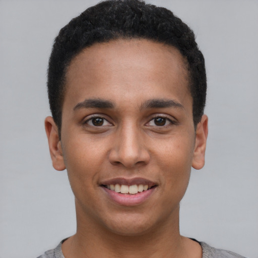 Joyful black young-adult male with short  black hair and brown eyes