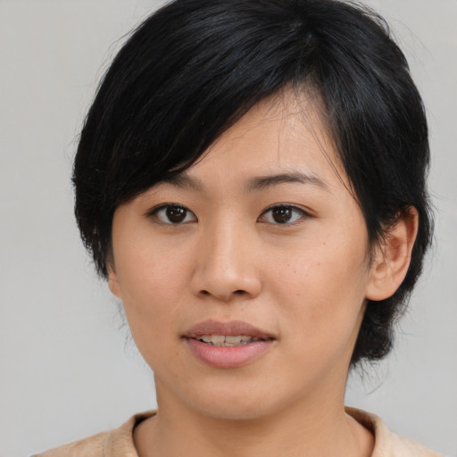 Joyful asian young-adult female with medium  brown hair and brown eyes