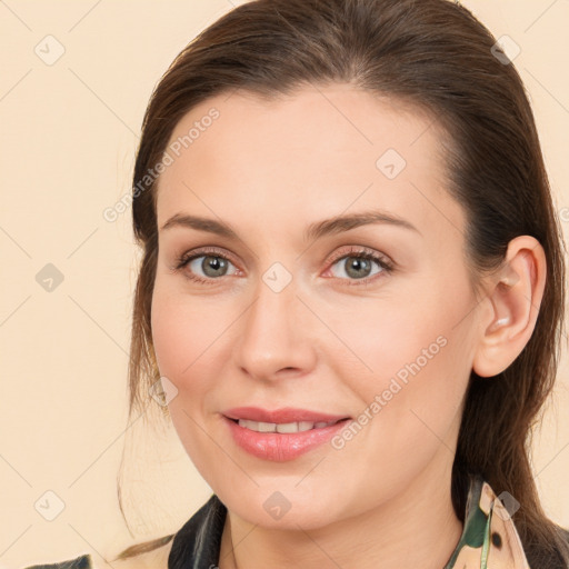 Joyful white young-adult female with long  brown hair and brown eyes