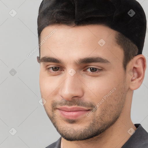 Joyful white young-adult male with short  brown hair and brown eyes