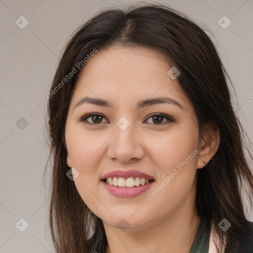 Joyful latino young-adult female with long  brown hair and brown eyes