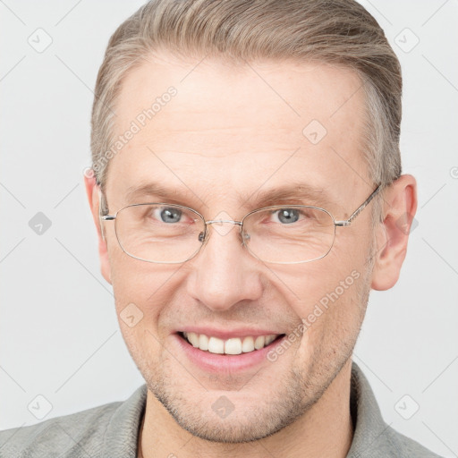 Joyful white adult male with short  brown hair and grey eyes