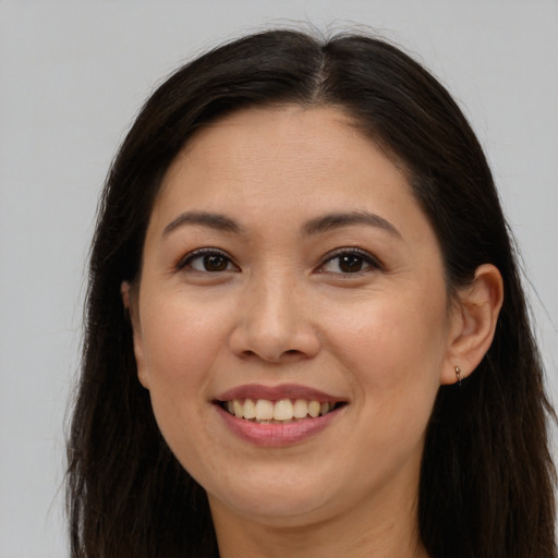 Joyful white young-adult female with long  brown hair and brown eyes