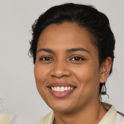 Joyful latino young-adult female with short  brown hair and brown eyes