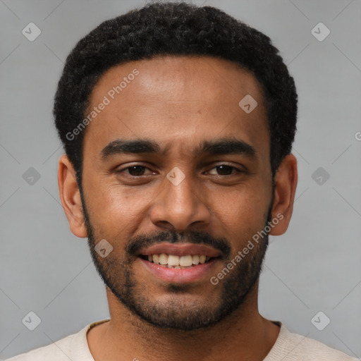 Joyful black young-adult male with short  black hair and brown eyes