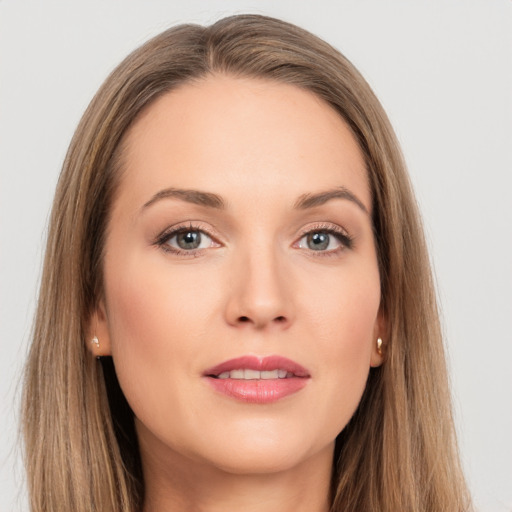 Joyful white young-adult female with long  brown hair and grey eyes