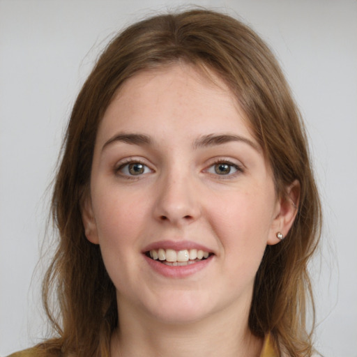 Joyful white young-adult female with medium  brown hair and grey eyes