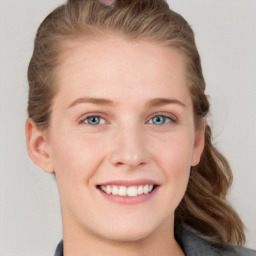 Joyful white young-adult female with long  brown hair and blue eyes