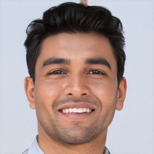 Joyful latino young-adult male with short  black hair and brown eyes