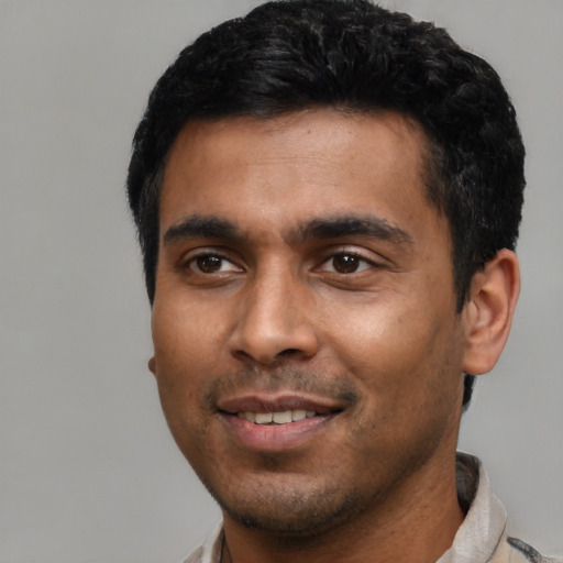 Joyful latino young-adult male with short  black hair and brown eyes