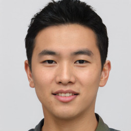 Joyful asian young-adult male with short  black hair and brown eyes