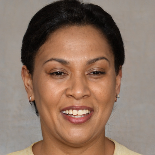 Joyful latino adult female with short  brown hair and brown eyes