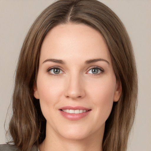 Joyful white young-adult female with medium  brown hair and green eyes